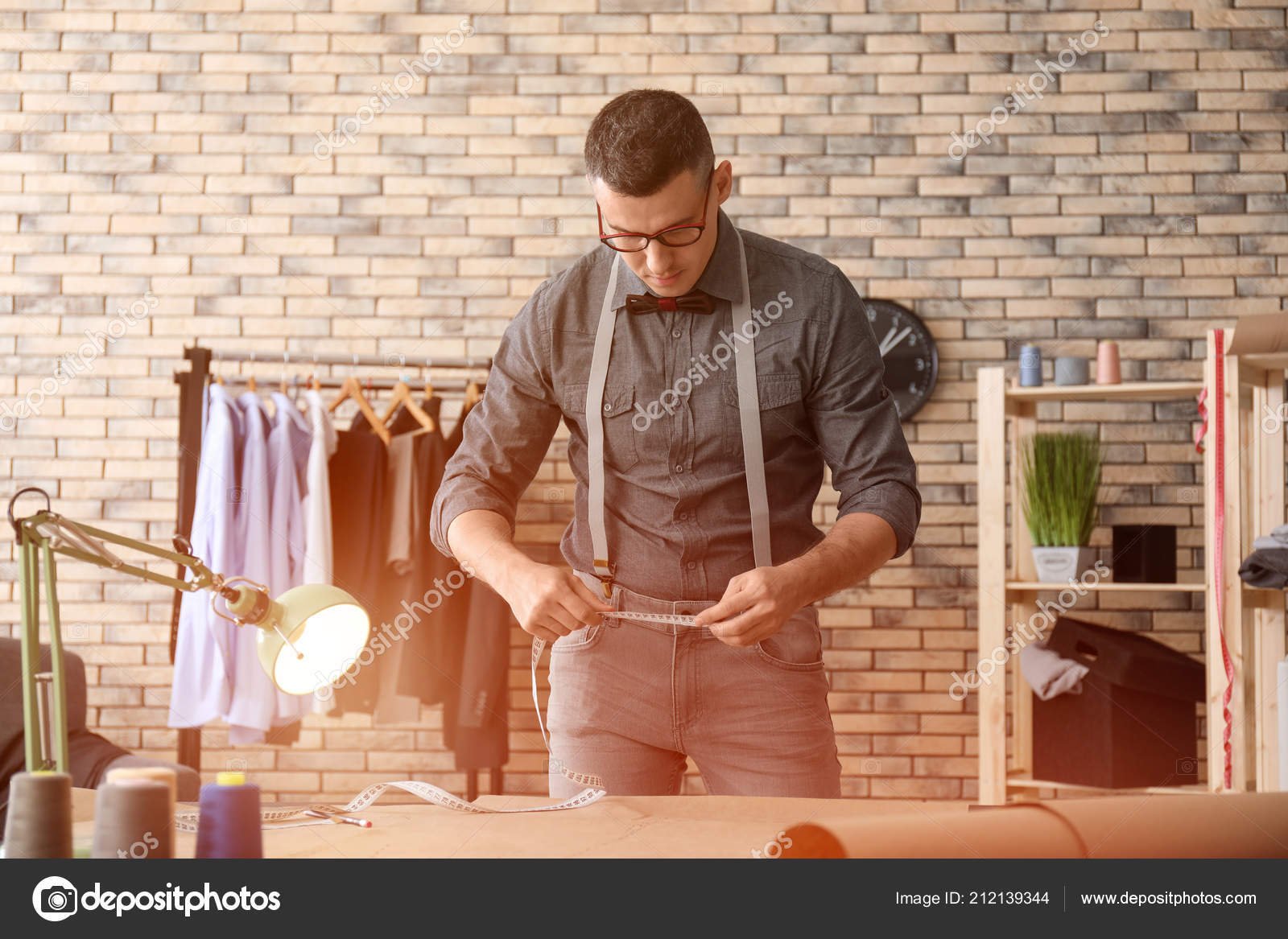 depositphotos_212139344-stock-photo-young-tailor-working-atelier