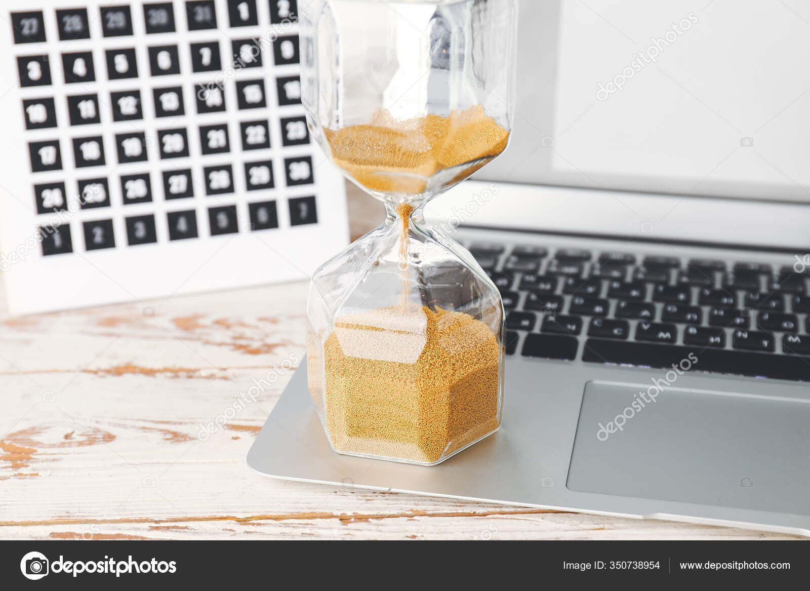 depositphotos_350738954-stock-photo-laptop-calendar-hourglass-table-deadline