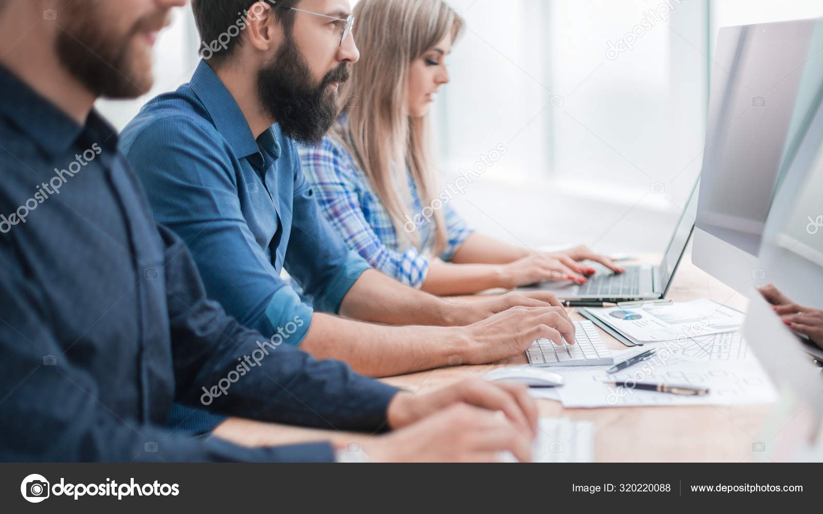depositphotos_320220088-stock-photo-group-employees-using-computers-to