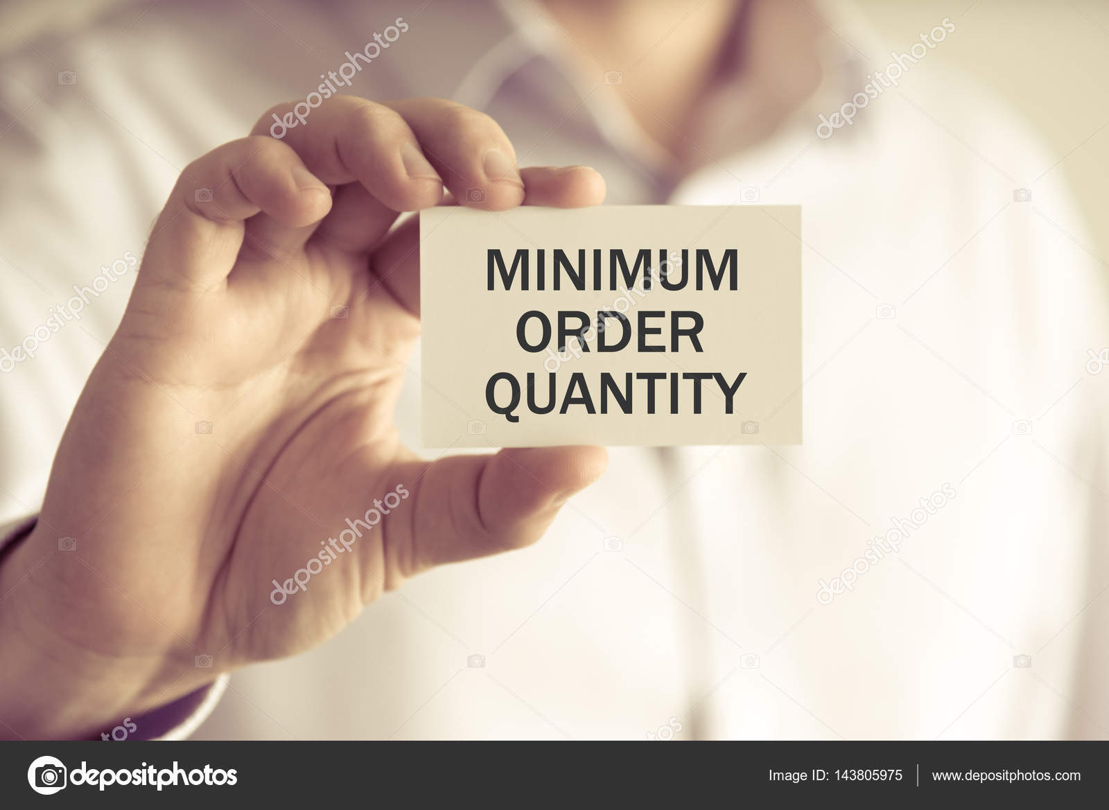 depositphotos_143805975-stock-photo-businessman-holding-minimum-order-quantity