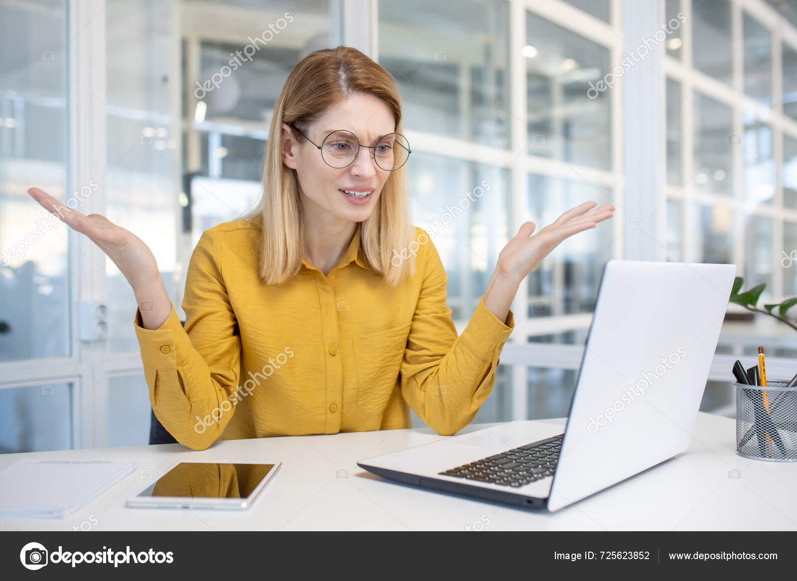 depositphotos_725623852-stock-photo-frustrated-businesswoman-yellow-shirt-using
